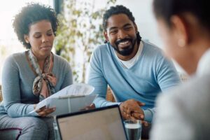 A family reviewing insurance documents together in a comfortably furnished living room.